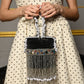 Rajwada Black Embellished Cylindrical Clutch With Tassels For Women